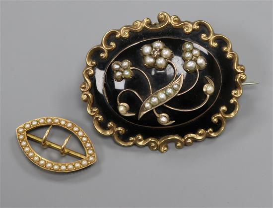 An Edwardian 15ct gold and seed pearl scarf clip and a yellow metal, seed pearl and black enamel mourning brooch, largest 51mm.